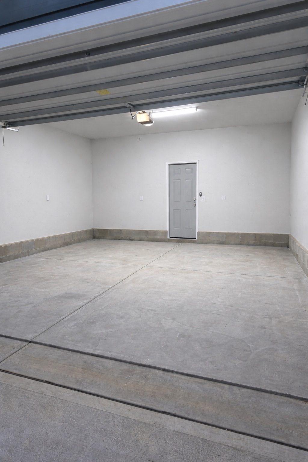 Finished two-car garage in Wake Forest, NC -- smooth drywall and painted walls by Forest Carpentry