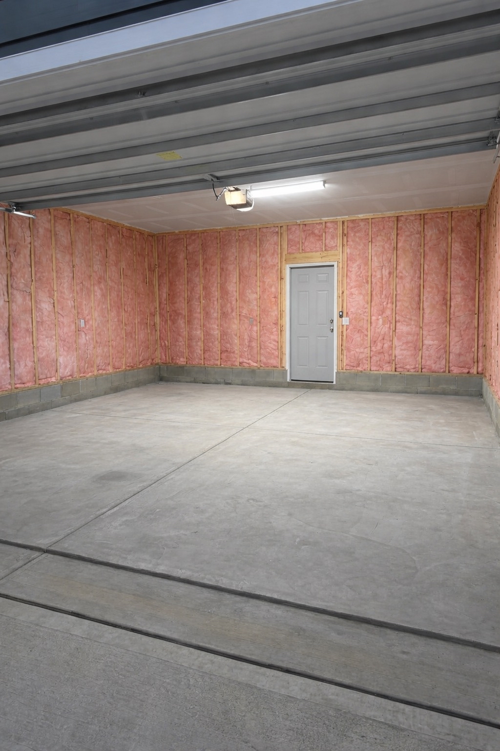 Garage renovation in progress -- insulation installed between wall studs in Wake Forest, NC